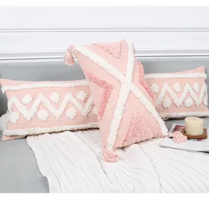 Pink boho tufted lumbar pillow cover with geometric pattern and tassels for cozy sofa decor.