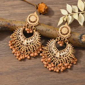 Bohemian vintage gold hollow long earrings with elegant nude beaded tassel drop design.