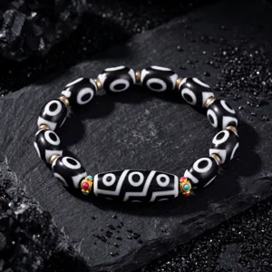 Tibetan Dzi bead bracelet, black white eye pattern stones, vintage fashion jewelry detail view.