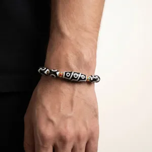 Tibetan dzi bead bracelet detail view, vintage ethnic style men accessory on wrist.