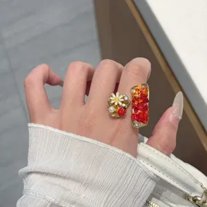 Detailed view of the vintage style colorful crystal insect ring with fine metal work.