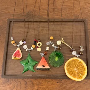 Spring summer dopamine fruit slice epoxy resin necklace detail, vibrant long sweater chain.