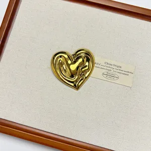 Vintage gold liquid heart brooch pin, abstract metallic aesthetic jewelry accessory.
