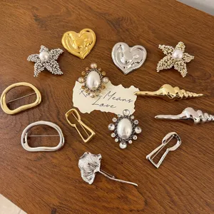 Set of vintage metal brooches, close-up details of heart, star, and pearl designs.
