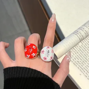 Chunky enamel drip oil metal ring set featuring cute floral patterns and sparkling center stones.