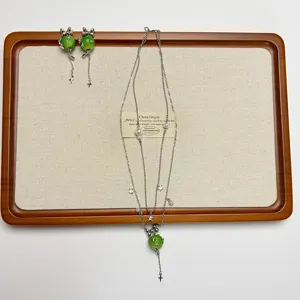 Exquisite green apple pendant necklace detail, stylish layered tassel clavicle chain accessory.
