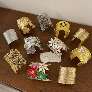 Detailed view of trendy European metal cuff bracelets with unique floral and geometric styles.