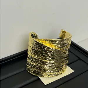 Gold wide textured cuff bracelet detail, statement open metal bangle for women fashion accessory.