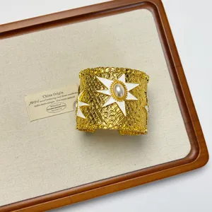 Exaggerated gold open cuff bracelet with white star and pearl, chic metal jewelry for women.