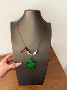 Charming green starfruit resin pendant necklace with colorful beads and long brown cord for women.