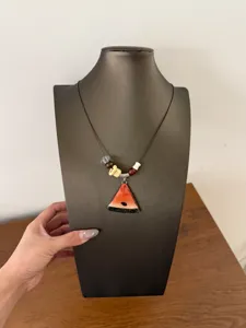 Close up of a cute watermelon slice resin pendant necklace with colorful beads on cord.