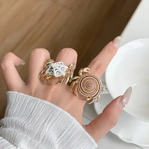 Detail shot of ocean style crab rings, metallic open finger jewelry with shell texture.