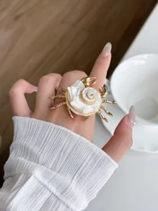 Detailed view of the bohemian ocean style shell crab ring, trendy gold metal open ring accessory.