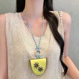 Closeup detail of colorful leather sunflower glasses holder necklace, unique long accessory.