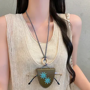 Detailed shot of a trendy leather sunflower glasses holder necklace, long multi-functional accessory for women.