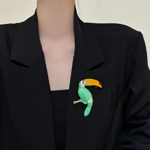 Colorful enamel toucan brooch pin for women, vintage style metal bird corsage suit accessory.