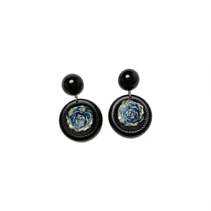Vintage black resin earrings featuring a detailed blue floral centerpiece and smooth top bead.