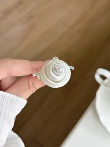 Close-up detail of the creative ocean style metal ring with unique pearl and shell design.