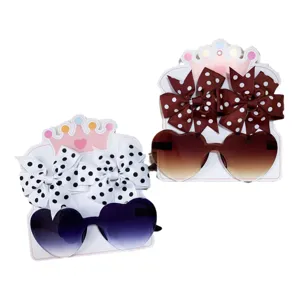 Set aus herzförmiger Sonnenbrille für Kinder und gepunkteten Haarschleifen
