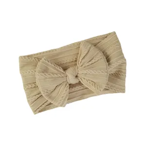 Diadema elástica de nailon para bebé con punto de ochos y un lazo decorativo grande en beige