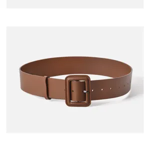 Brown wide leather belt detail shot, stylish coat waist cincher and decorative sweater accessory.