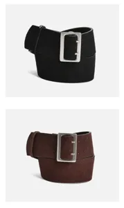 Close-up detail of wide suede leather belt with vintage metal rectangular buckle.