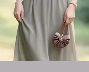 Detail shot of women fashion pleat dress and stylish handbag in outdoor lifestyle view.
