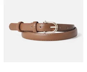 Brown leather belt detail closeup, elegant gold D-buckle design, minimalist womens accessory.