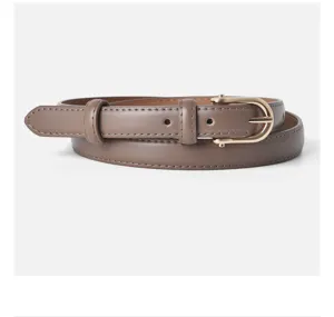 Detailed view of women's genuine leather slim belt with elegant gold-tone D-shaped pin buckle.