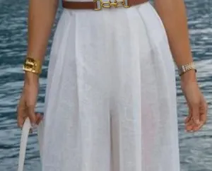 Detailed view of women's brown leather belt with luxury gold metal buckle fashion accessory.