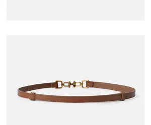 Close up view of the brown leather belt detail, showing the vintage metal buckle design clearly.