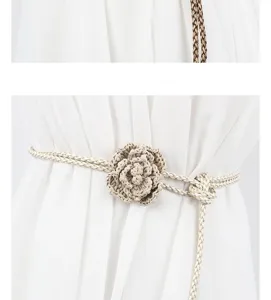 Close-up detail of a bohemian crochet flower braided waist belt, beige woven rope style.
