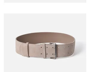 Wide suede leather women belt with double prong metal buckle and eyelet details closeup