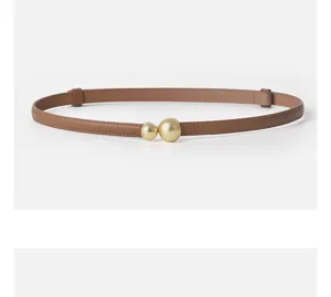 Women leather belt detail view featuring slim brown strap and stylish gold dual ball buckle design.