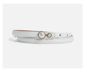 Close up detail of white thin leather belt featuring elegant double pearl buckle for dresses.