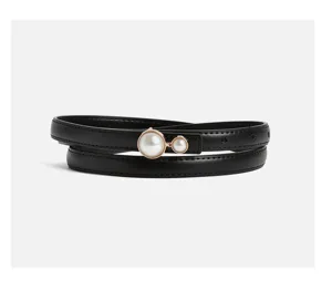 Minimalist black thin leather belt for women with pearl buckle detail, stylish dress accessory.