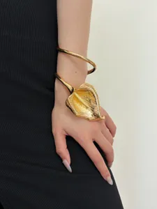 Detailed view of a stunning gold calla lily arm cuff, highlighting the glossy metallic texture.