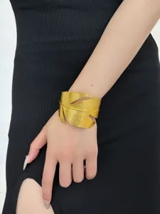 Gold leaf cuff bracelet for women, statement open metal wristband fashion accessory detail shot.