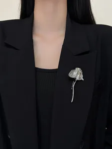 Exquisite silver metallic crumpled leaf brooch detail showcasing unique texture and elegant design.