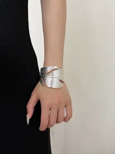 Close-up detail of a chic silver leaf open cuff bracelet showcasing unique metallic texture.