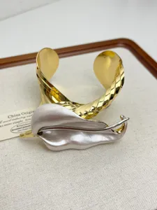 Detailed view of European metal fashion leaf cuff bracelet, luxury open bangle accessory.