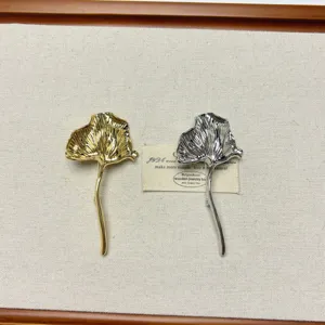 Vintage metallic ginkgo leaf brooch set, elegant retro design fashion jewelry accessory.