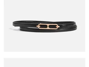 Black thin leather belt with chic rose gold interlocking oval buckle for elegant dresses.