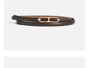 Detailed view of the elegant dark brown skinny leather belt with gold metal buckle.