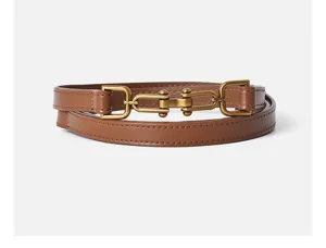 Close-up of brown leather belt with vintage metal buckle, chic waist accessory details.