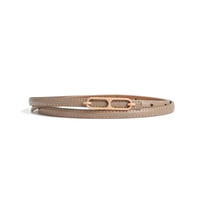 Elegant women thin leather belt with metal buckle, stylish waist accessory for dresses.