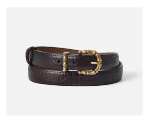 Detail shot of women luxury crocodile pattern leather belt featuring unique gold bamboo buckle.