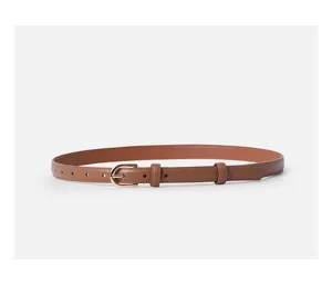 Minimalist women genuine leather belt detail shot with gold buckle and slim brown strap style.