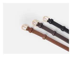 Minimalist women's thin leather belt detail, classic gold metal buckle, versatile design.