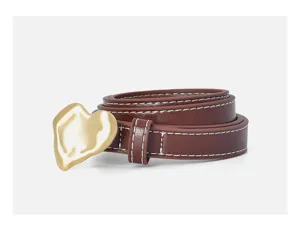 Detail shot of brown leather belt with gold irregular heart buckle and white stitching.